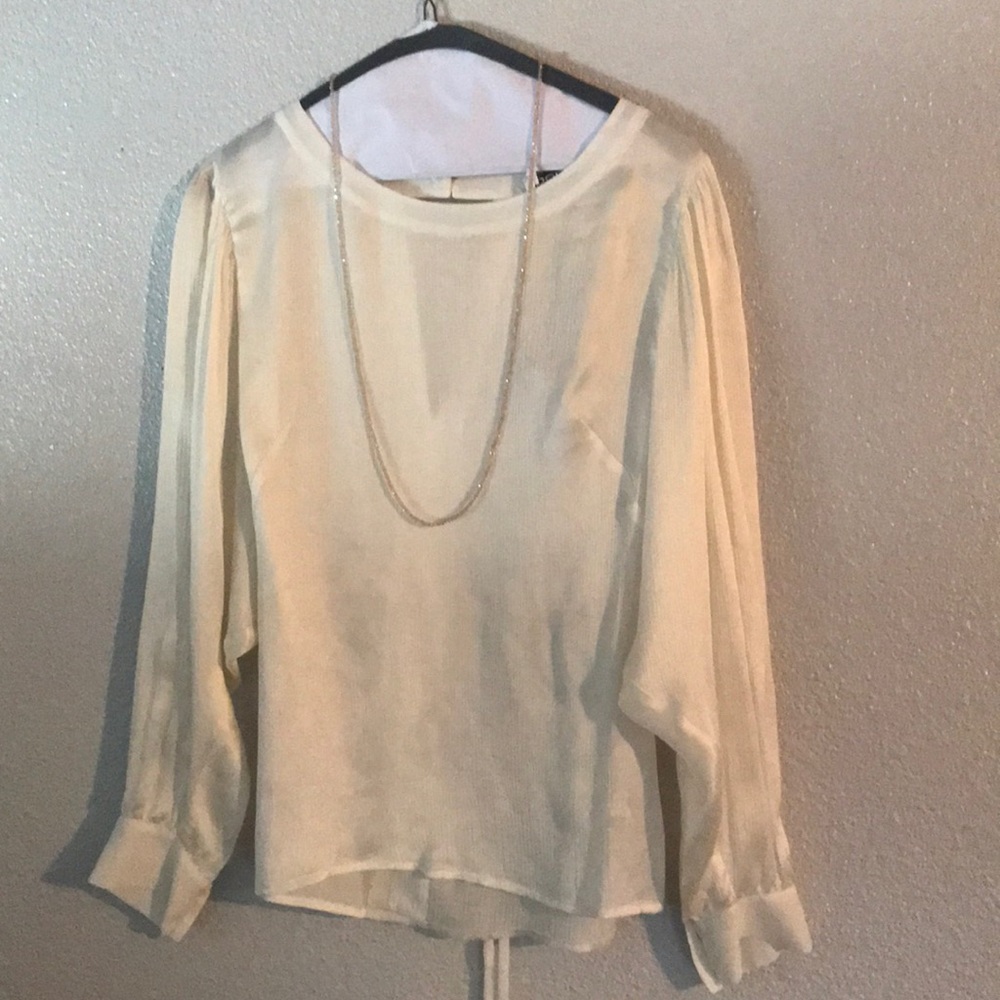 Bebe Size Medium cream long sleeve silk blouse.